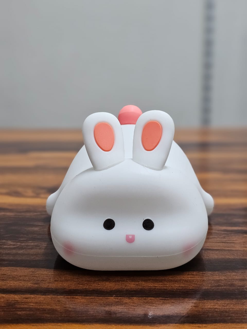 Big Face Rabbit Silicone Night Lamp on a wooden table turned off
