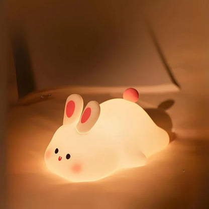 Big Face Rabbit Silicone Night Lamp on a bed