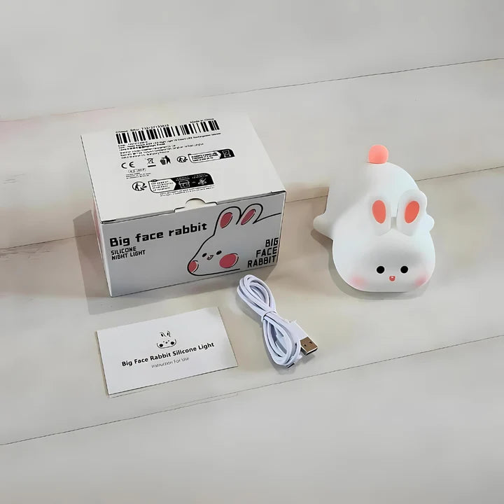 Big Face Rabbit Silicone Night Lamp on a white surface with packaging box and charging wire