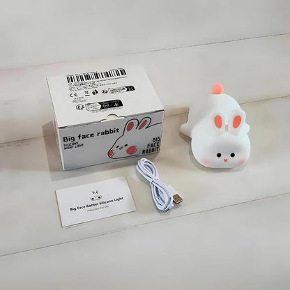 Big Face Rabbit Silicone Night Lamp on a white surface with packaging box and charging wire