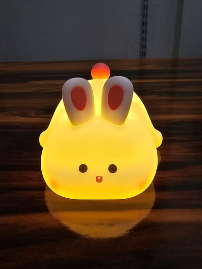 Big Face Rabbit Silicone Night Lamp on wooden table